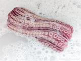 cleaning silicone sex toy in warm soapy water for hygiene