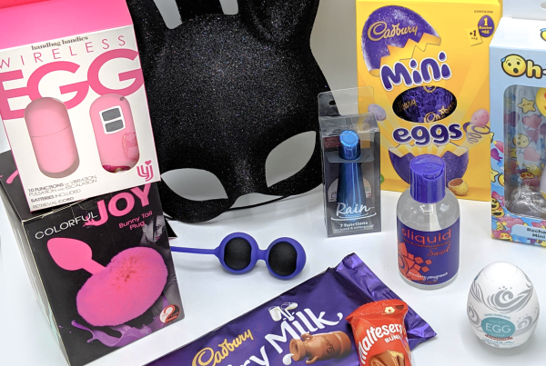 Easter-themed display of sex toys including egg toy, bunny tail plug, egg-shaped masturbator, bunny face mask and various chocolate treats
