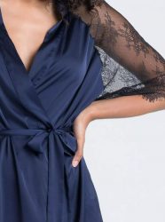 Close-up of a dark blue wrap style lingerie robe tied at the waist, with sheer lace detail sleeve.