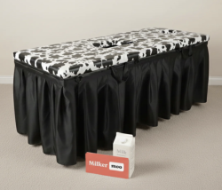 Milking table which folds flat after use for convenient storage