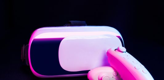 Virtual reality headset and controllers representing interactive sex toys and digital intimacy technology