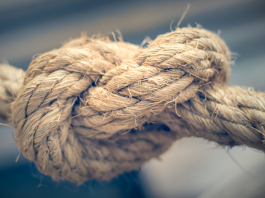 Aftercare After Sex: How to Reconnect, Recover and Deepen Intimacy Close-up of a thick rope tied in a firm knot, showing texture and wear