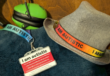 Ear defenders, an “I am autistic” lanyard and autism identification card used by a neurodivergent teenager.