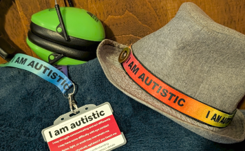 Ear defenders, an “I am autistic” lanyard and autism identification card used by a neurodivergent teenager.