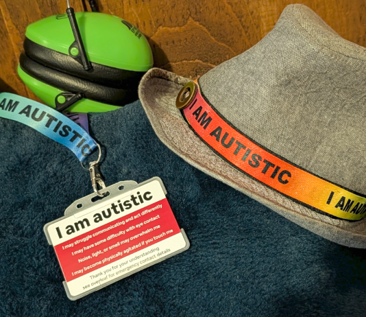 Ear defenders, an “I am autistic” lanyard and autism identification card used by a neurodivergent teenager.