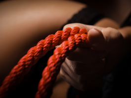 Fetish Psychology: Why Kinks Turn Us On and What They Mean Hand gripping red bondage rope symbolising kink and fetish exploration