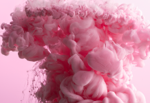 Pink ink swirling in water symbolising the experience of orgasm and sexual pleasure