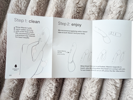 We-Vibe Wand 2 quick start guide showing Step 1 clean and Step 2 enjoy instructions with illustrations of cleaning and use with lubricant