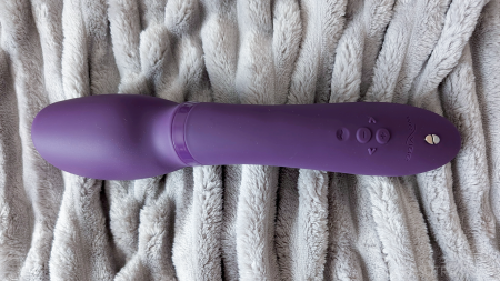 We-Vibe Wand 2 photographed from the side showing the full length of the wand, buttons and charging pin