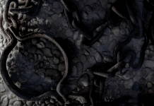 Rusted iron shackle and tangled chains on cold stone floor, cool-toned close-up