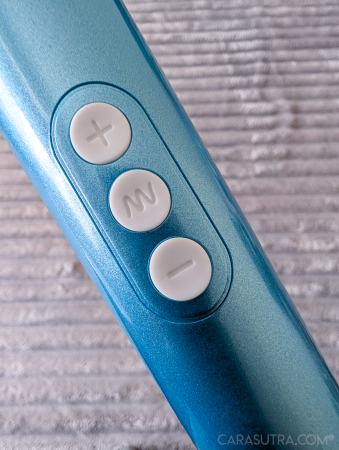 Close up of the three white silicone operation buttons on Le Wand Dive's handle: plus, zigzag symbol, and minus