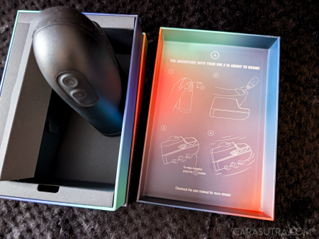 Arcwave Ion 2 stroker inside its open retail box with usage instructions inside the lid visible