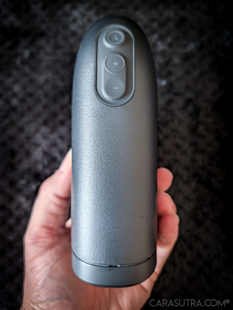 Arcwave Ion 2 held in hand, showing the control buttons on the front of the matte black body