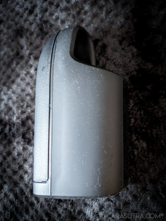 Arcwave Ion 2 laid sideways on a black blanket, showing the smooth surface of the outer of the silicone sleeve