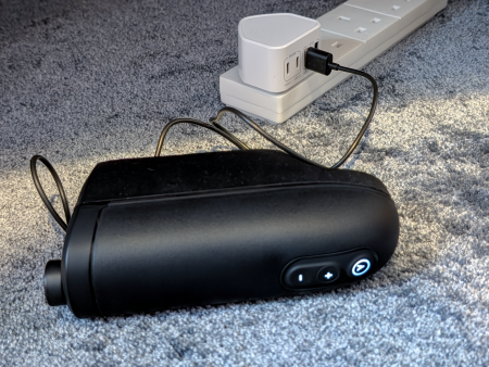Arcwave Ion 2 charging via its magnetic lead plugged into a white milti USB to mains plug
