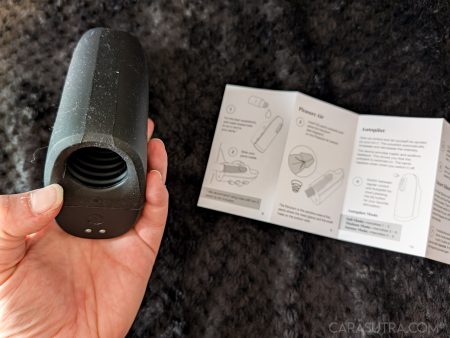 Arcwave Ion 2 held in hand with the quick start guide visible in the background