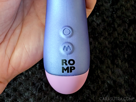 The base of the ROMP Pulse Rabbit held in hand, showing the two raised control buttons and ROMP logo