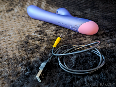 The ROMP Pulse Rabbit Vibrator beside its coiled USB charging cable