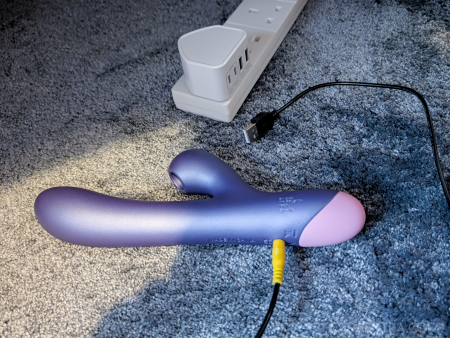 The ROMP Pulse Rabbit charging, its cable plugged into a USB mains adaptor