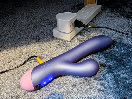 The ROMP Pulse Rabbit charging with its blue LED control buttons lit up